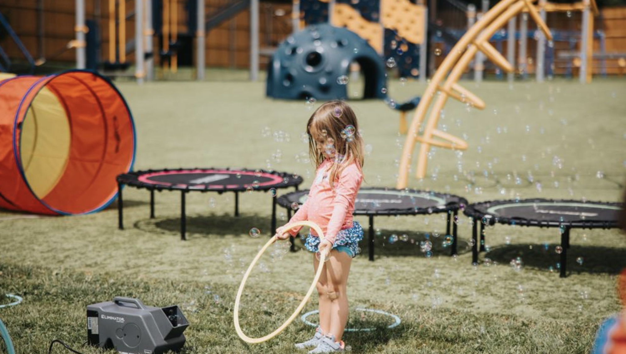 Toddlers bouncing on mini trampolines