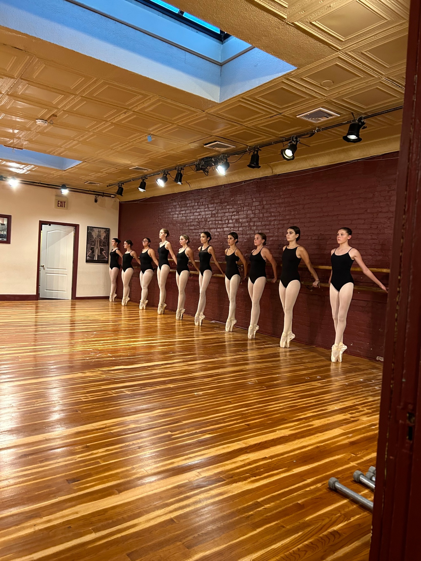 Ballerina in arabesque under stage light